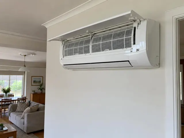 Open split system on a white internal wall above a living area, with clean filters visible in Mitcham